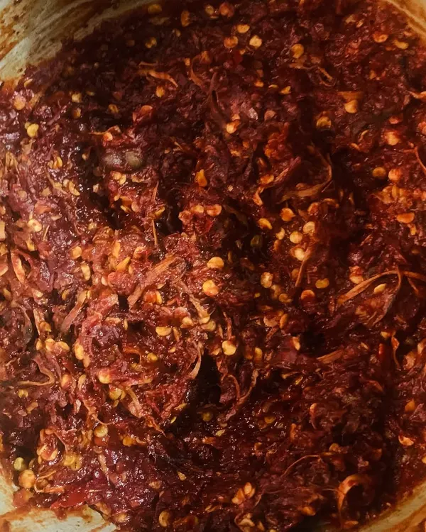 This is Etsu Molu, our traditional red chilli chutney. It's fiery and full of flavour, made by pounding together fresh king chillies, garlic, and other spices. A little bit of this goes a long way to spice up any meal.