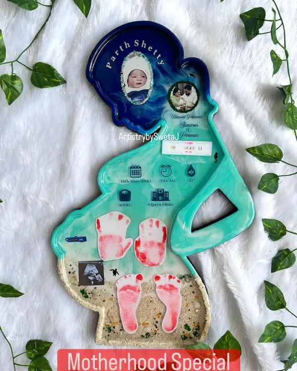 This is my "Motherhood Special" keepsake, shaped in the silhouette of an expecting mother. It holds the entire story: birth stats, the first ultrasound, baby's handprints and footprints, and photos of the newborn and parents.