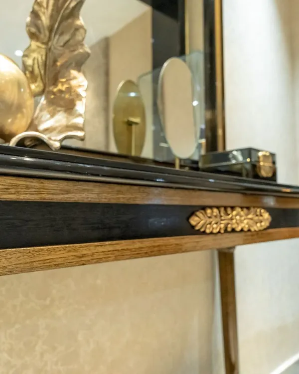 Craftsmanship is at the heart of my design philosophy. This close-up shows a handcrafted console table with intricate gold-leaf detailing and carved wooden elements, created to be a unique and personal piece for a client's luxurious living space.