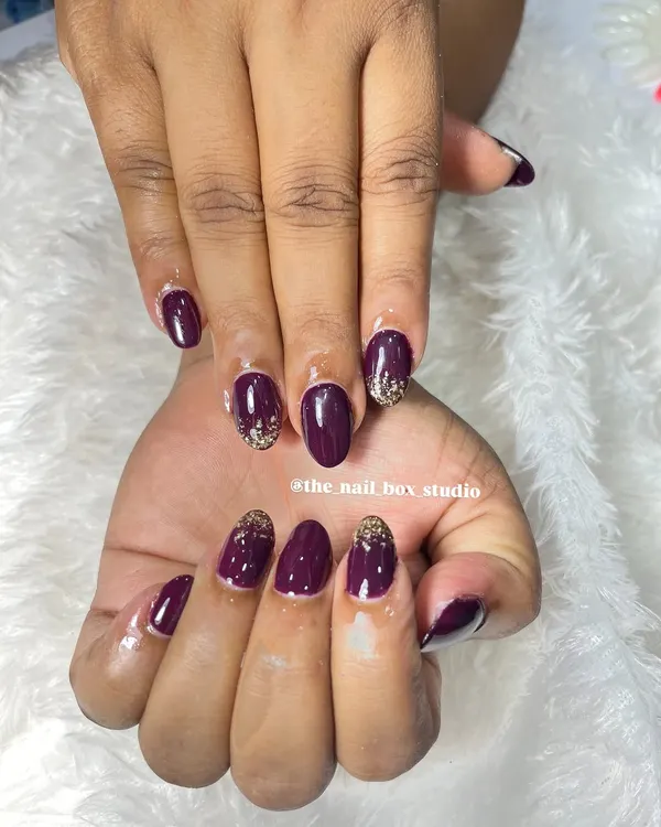 A beautiful set of soft gel extensions with a deep plum gel polish. I added a touch of gold glitter at the cuticles for a reverse glitter ombré effect, which adds a bit of sparkle and elegance.