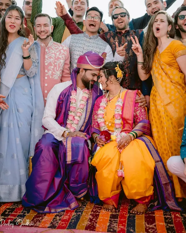 The best celebrations are shared with friends and family. This fun group shot captures the couple surrounded by the joyous energy of their loved ones during their wedding in Satara.
