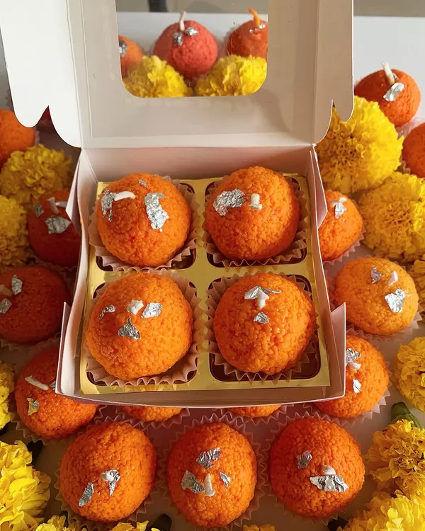 This is my signature Ladoo Candle, designed to bring a festive feel to your home. I handcraft each one to look just like a real Motichoor Ladoo, complete with silver foil, making it a perfect, unique gift for celebrations like Diwali.