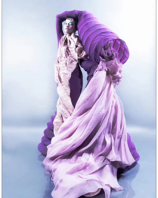 A full-length shot from my 'Chemical Reaction' series, where a model is enveloped in a dramatic, sculptural purple and pink garment. This image captures the project's core idea of fashion representing the fluidity and flamboyance of emotional chemistry.