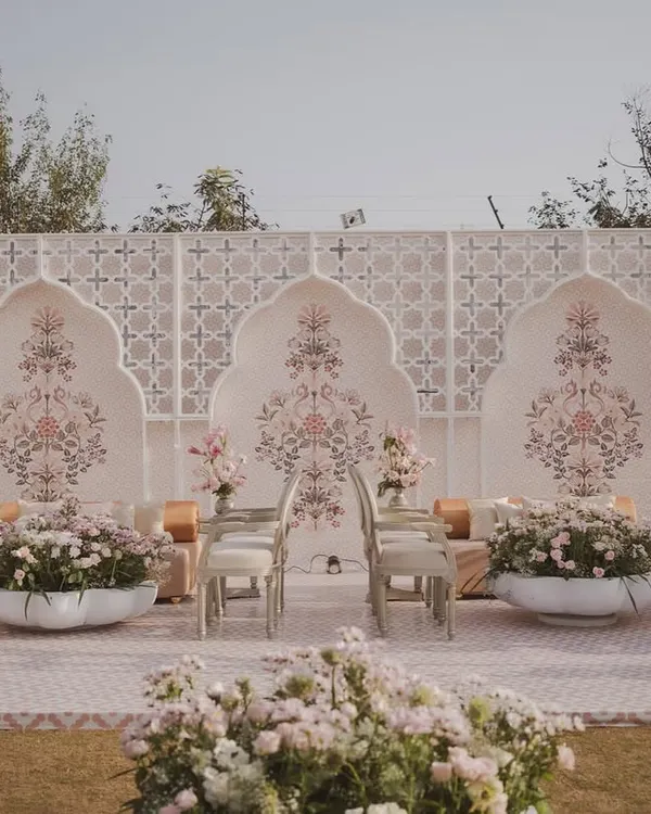 We created a modern 'Mughal Garden' for this Jaipur wedding, using a soothing palette, intricate backdrops, and lush florals to evoke palatial elegance.