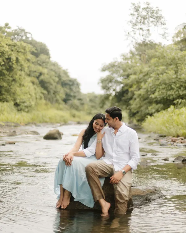 A quiet moment of togetherness, sitting on a rock in a gentle river. This natural light pre-wedding shoot is for couples who find romance in the simplicity and beauty of the outdoors.