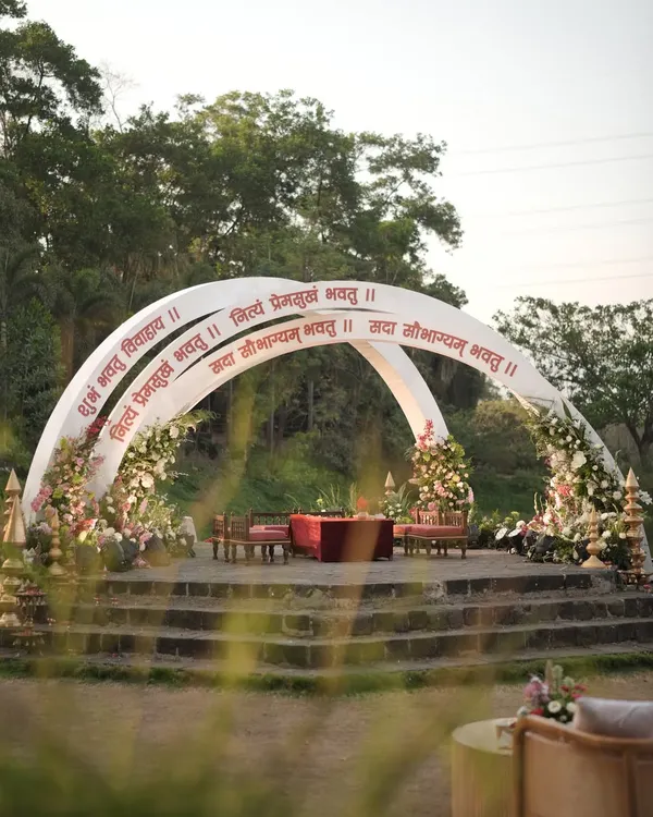 The 'Mantram' mandap was designed to feel like a blessing. The clean, modern arches inscribed with Sanskrit verses and framed by soft, romantic florals created a space that was both visually stunning and spiritually resonant.