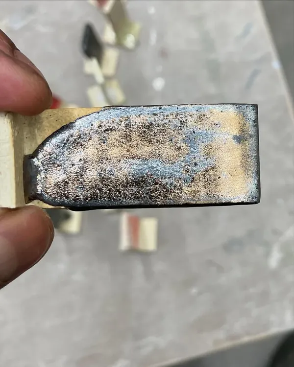 A close-up of a glaze test tile. This one developed a beautiful metallic, crystalline effect during firing. Testing is crucial for discovering new and exciting surfaces for my work.