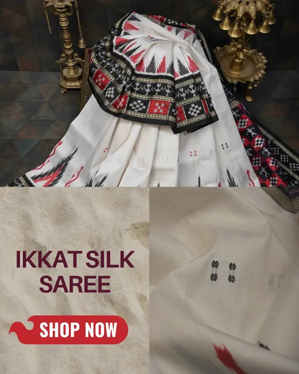 A classic Pochampally Ikkat silk saree in white, red, and black. The sharp, geometric patterns on the border and pallu are a hallmark of this incredible weaving technique.
