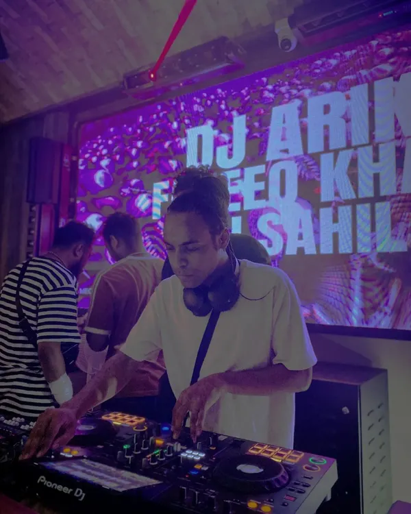 DJing under the purple lights of a packed club. I adapt my set to the venue, whether it's a high-energy nightclub or a chill lounge.