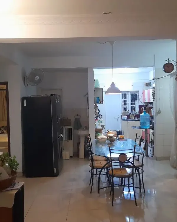 **BEFORE:** This living and dining area felt disconnected and cluttered, with structural elements breaking the flow. The space lacked a clear identity and was not optimized for family interaction.