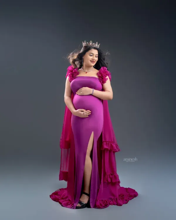 Feel regal in a bold magenta gown with a dramatic cape. I style these shots with accessories like a crown to complete the royal look, ensuring you feel confident and beautiful.