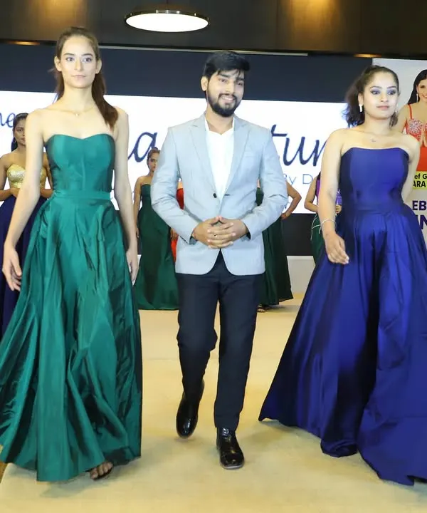 A proud moment for me on the runway at the Celebrity Business Awards. My collection of custom gowns, including these jewel-toned green and blue pieces, was showcased on the ramp. It’s always amazing to see my designs come to life.