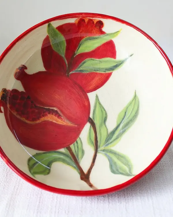 This hand-painted ceramic bowl is a piece of art for your table. I shape each one by hand and then paint the vibrant pomegranate motif, making every bowl a unique celebration of color and tradition.