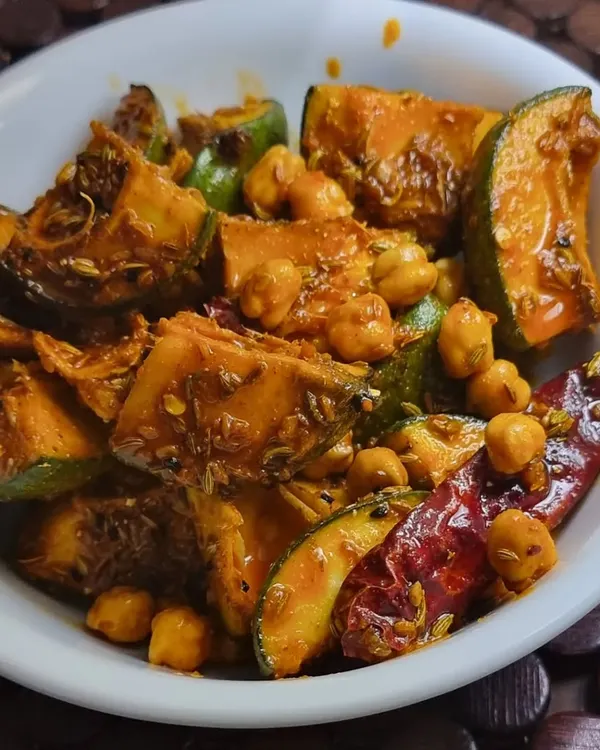 My special Aam Chana pickle, a true Punjabi classic. It has the perfect tangy kick from raw mangoes and a wonderful texture from the chickpeas, all mixed in pure mustard oil with my secret blend of spices.