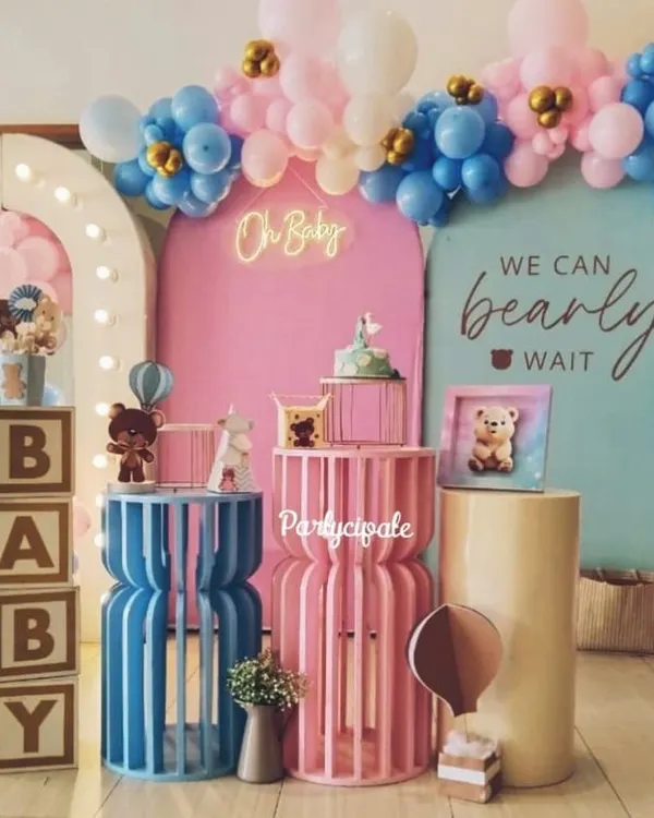 A beautiful 'We Can Bearly Wait' baby shower setup. The combination of pink and blue balloons, a light-up arch, and 'BABY' blocks creates a perfect backdrop for celebrating the parents-to-be.