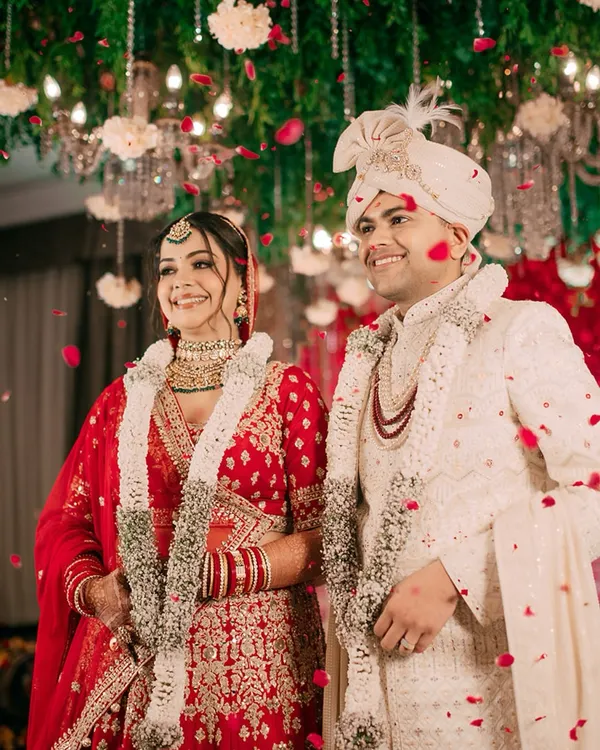 The magical moment of the varmala ceremony, showered in petals and blessings. We capture the pure joy and radiance of the couple as they officially begin their life together.