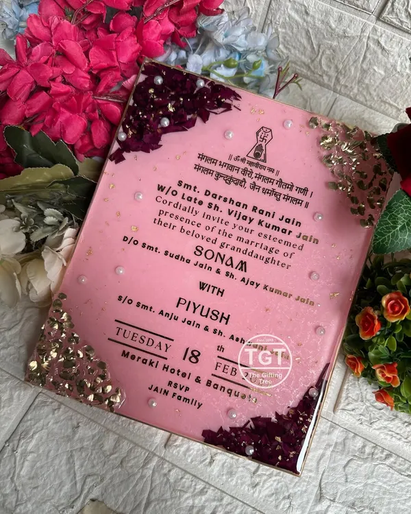 This 8x10 inch resin invitation was designed as the special first invite exchanged between families. It features preserved rose petals and stone work on the corners.