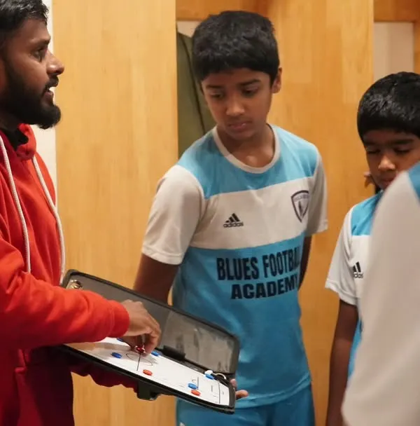 It all starts with a plan. Our licensed coach uses a tactics board to explain positional play to our youth team before a match. We focus on developing intelligent players who understand the game on a deeper level.