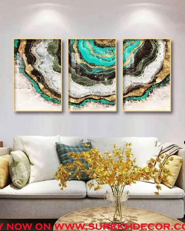 A triptych of crystal paintings that mimic the natural patterns of agate stone in vibrant teal, black, and gold. This set creates a powerful and luxurious statement above a sofa.