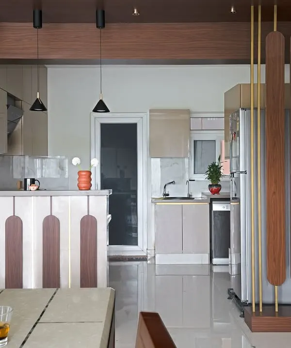 I reconfigured this kitchen in 'The Flux Abode' from a galley to an open U-shape. The design features a breakfast bar with unique paneling that separates it from the dining area while maintaining an open feel.
