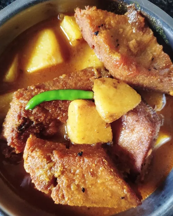 Dhokaar Dalna brings back so many memories of 'biyebari' (wedding) feasts from my childhood. These are savory lentil cakes, first fried and then simmered in a fragrant gravy with potatoes. It's my go-to dish for a hearty vegetarian meal.