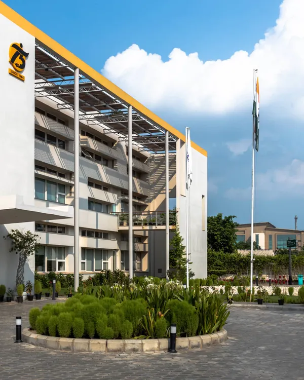 The exterior of a LEED Platinum certified office building I designed in Greater Noida. The design incorporates large overhangs and a prominent solar panel array on the roof, showcasing its sustainable credentials from the outside.