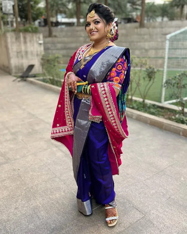 A full view of this stunning Marathi bride in her Nauvari saree. The draping is traditional and elegant, allowing her to move with confidence and grace.