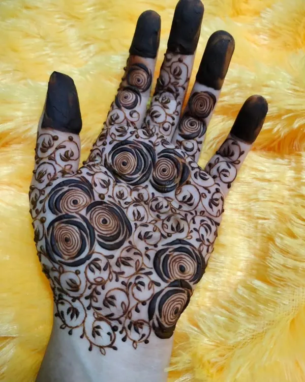 A unique and modern design featuring a net of spiraling roses. This is a fun twist on the classic 'jaal' pattern.