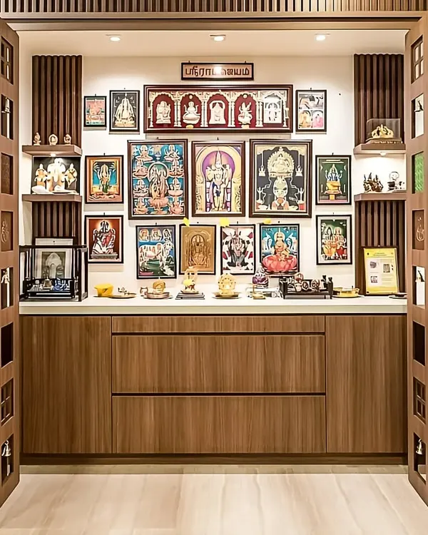 A traditional pooja room with beautiful wooden doors featuring small bells. The interior is designed for displaying multiple frames and idols.