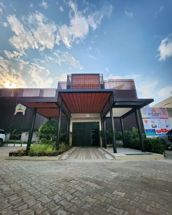 The redesigned entrance of a school, where we integrated a new covered walkway, a green courtyard, and a terracotta jaali screen. The design creates a welcoming and modern first impression that reflects the school's vision.