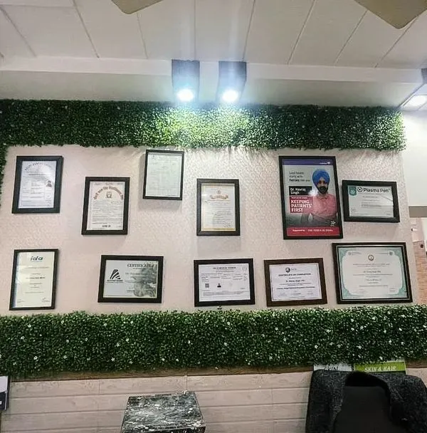 For this clinic in Shiv Nagar, we created a custom green frame around the wall displaying medical certificates. This unique design highlights the doctor's credentials while adding a professional and calming element to the reception area.