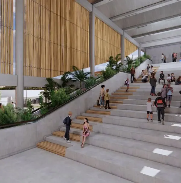 The main amphitheater-style staircase at Urban Gurukul, designed as a multi-use space for interaction, performances, and informal learning. The use of bamboo screens and integrated planters brings nature into the core of the building.