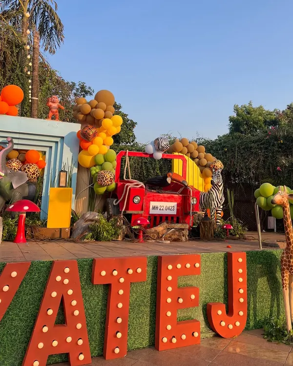For this 'Wild Two' jungle themed birthday, we created a massive custom stage with marquee letters, a waterfall feature, and life-sized animal props to serve as the perfect backdrop for the celebration.
