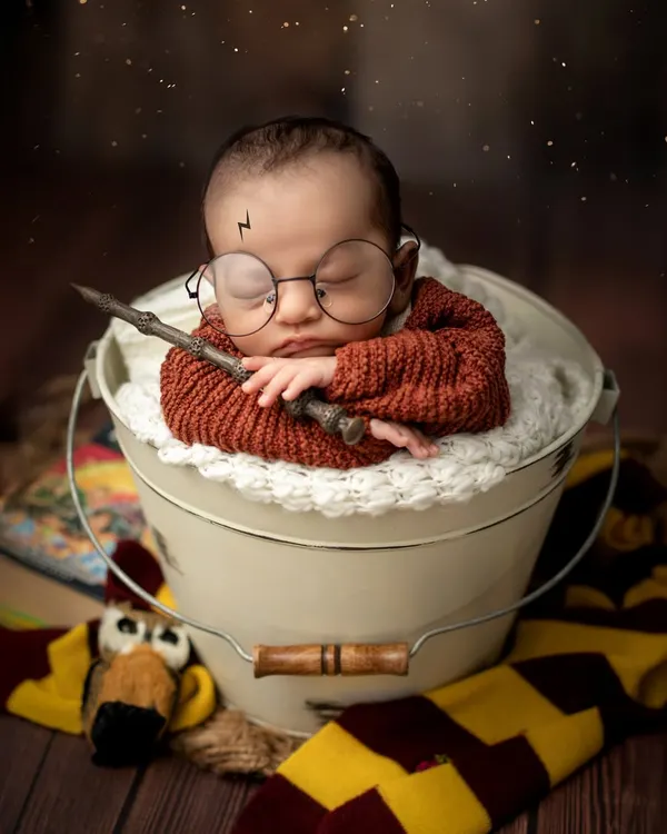 The boy who slept. This magical Harry Potter setup is complete with a wand, glasses, and a Gryffindor scarf, perfect for the newest fan in the family.