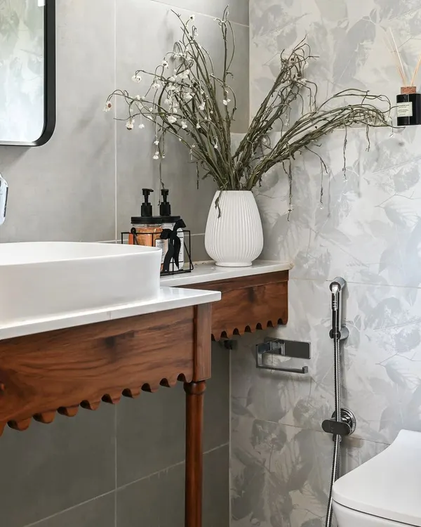 A close-up of the custom solid wood vanity in the Modern Spanish powder room. The arch details and spindle legs were thoughtfully designed to create an elegant and memorable feature, proving that even the smallest rooms can have a huge design impact.