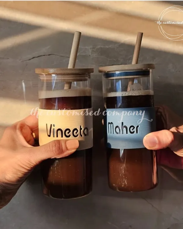 Beat the heat with a refreshing drink in these personalized glass sippers. Held against the sunlight, this image captures the perfect summer vibe, making them an ideal gift for friends, colleagues, or yourself.