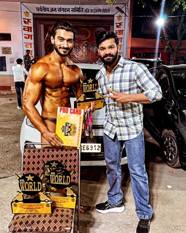 This is what victory looks like. Holding my PRO CARD and Mr. World trophies is proof that my methods work. I bring this same champion mindset and strategy to every athlete I coach.