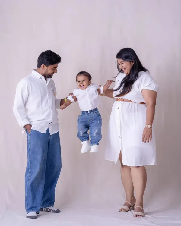 Sometimes the best shot is the one filled with action and laughter. This playful moment, with their toddler mid-air, is pure joy. It’s a perfect example of the fun, candid family photography we love to create.