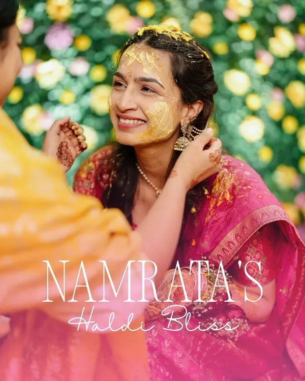 The Haldi glow is real. This beautiful close-up captures the bride's blissful smile as her family applies the sacred turmeric paste.