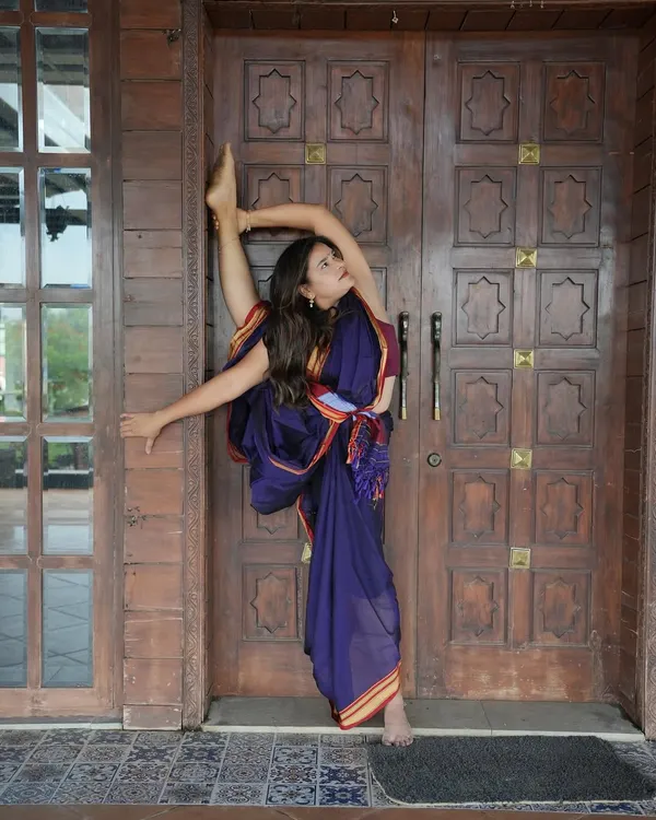 I practiced yoga in a saree today at a stunning ranch. This standing split, or Urdhva Prasarita Eka Padasana, shows that yoga doesn't need perfect clothes, just presence.
