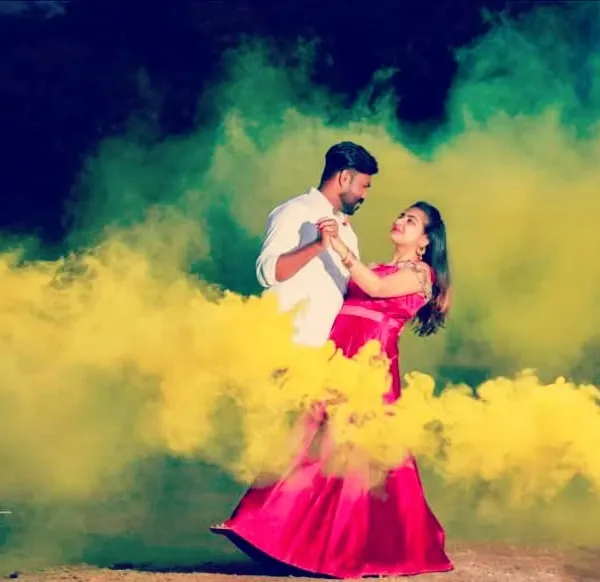 Using colored smoke bombs to create a vibrant and dreamy atmosphere for a couple's dance.