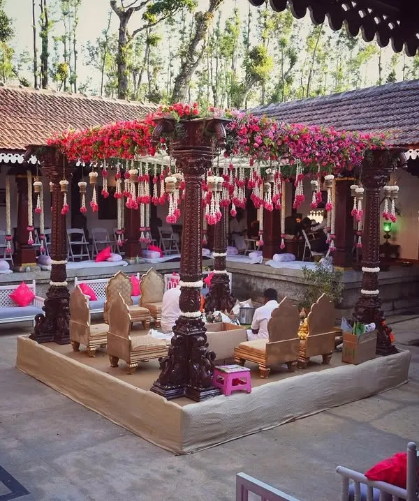 A full view of the ceremony setup within a 240-year-old Thottimane, where I used antique pillars for the mandap to complement the venue's historic architecture.