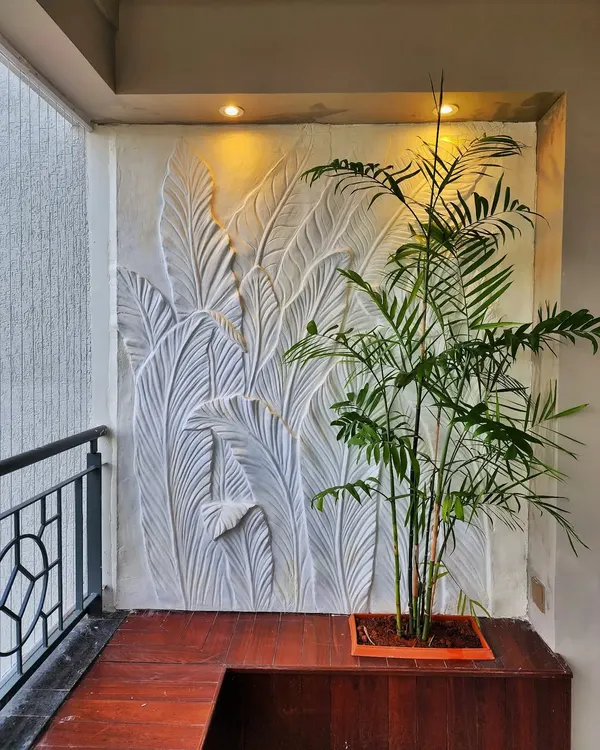 This 3D sculptural wall art was created for a residential balcony to add a touch of nature-inspired elegance. We used a fiber and plaster molding process to craft the overlapping tropical leaf design.