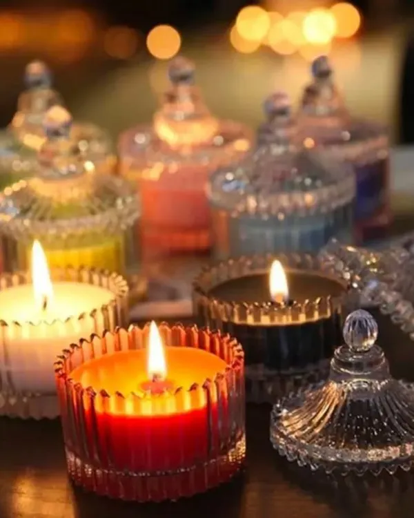 My signature scented candles, lit to create a warm and inviting atmosphere. These elegant crystal jars not only smell amazing with your choice of fragrance but also serve as beautiful home decor pieces long after the wax is gone.