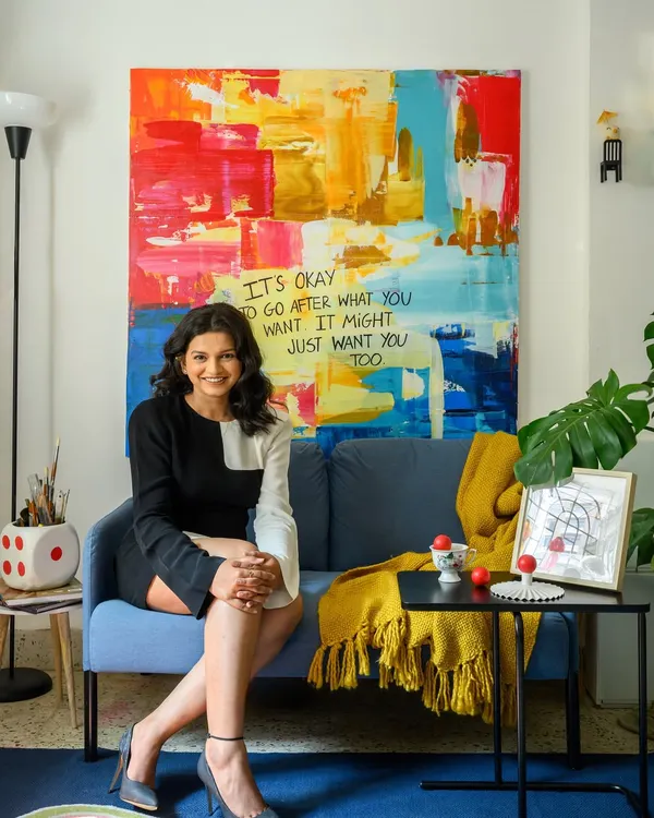 A portrait of me in my studio, a space where the lines between art and design blur. The large abstract painting behind me is a testament to the idea that it's okay to go after what you want.