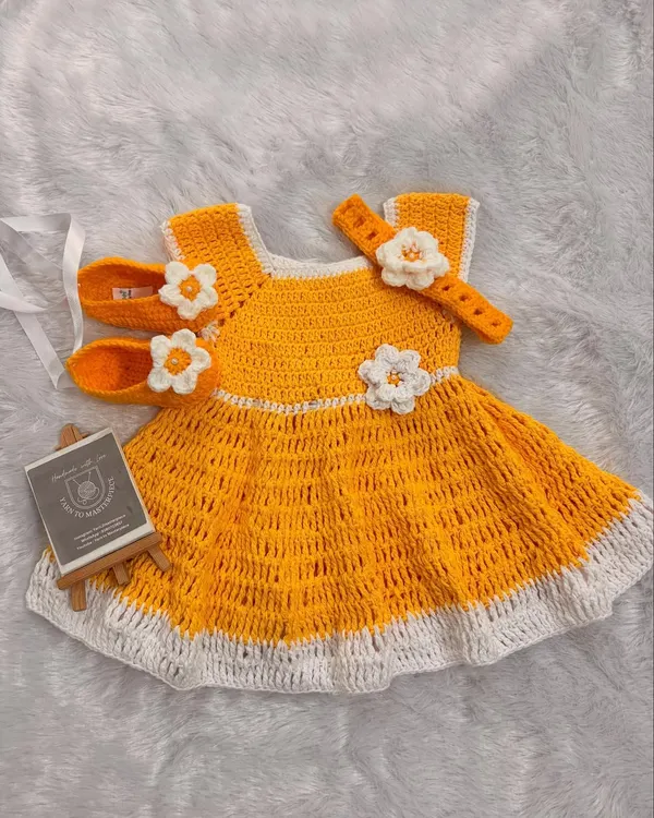 This cheerful yellow frock set is one of my favorite creations. It includes a lightweight, breathable crochet dress, matching floral booties, and a comfortable headband, making it a complete, picture-perfect outfit for any special day.