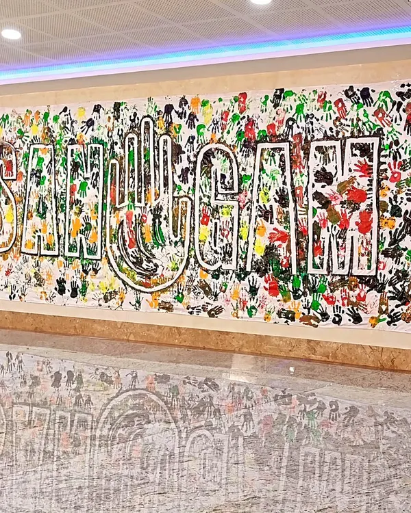 The final "SANGAM" handprint banner, created during a workshop with social workers and activists from across India. Each handprint represents an individual coming together to form a collective whole.