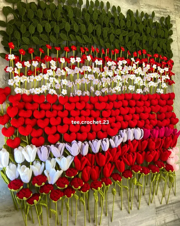 A massive wall of handmade crochet flower stems, showcasing the scale of my production for wholesale orders.