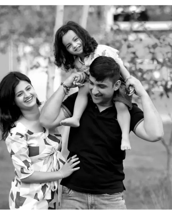 A happy family enjoying a day out in the park. I love capturing these relaxed, candid moments, like a daughter enjoying a shoulder ride from her dad.