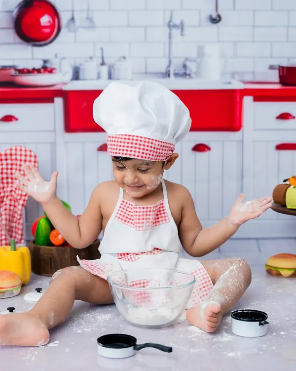Getting messy is part of the fun in my toddler chef-themed photoshoots. This little baker is having a blast with the flour!